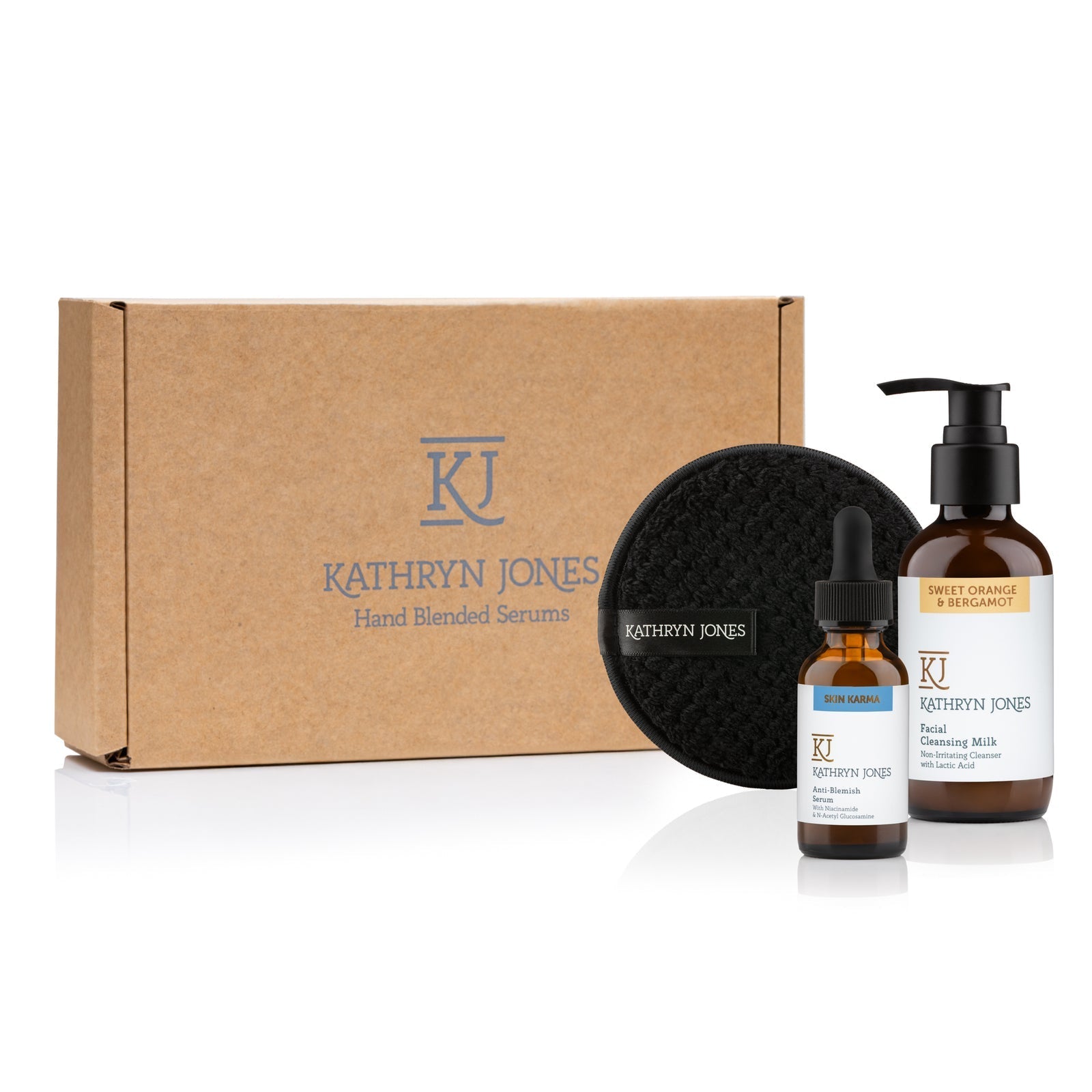 Kathryn Jones skincare product set including a box, bottles, and a black pad on a white background.