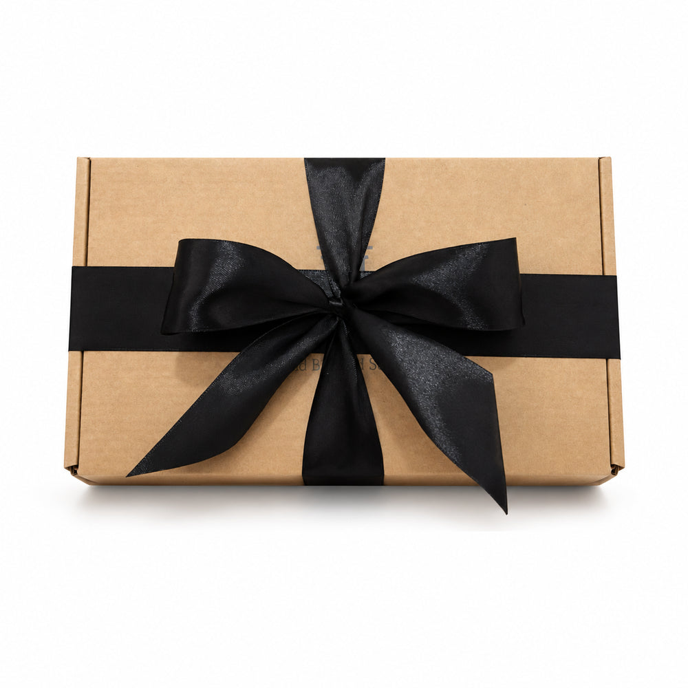 Brown gift box with a black ribbon on a white background for luxury skincare gifting