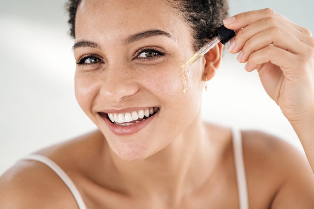 Woman applying liposomal retinol serum with a dropper for smoother, younger-looking skin