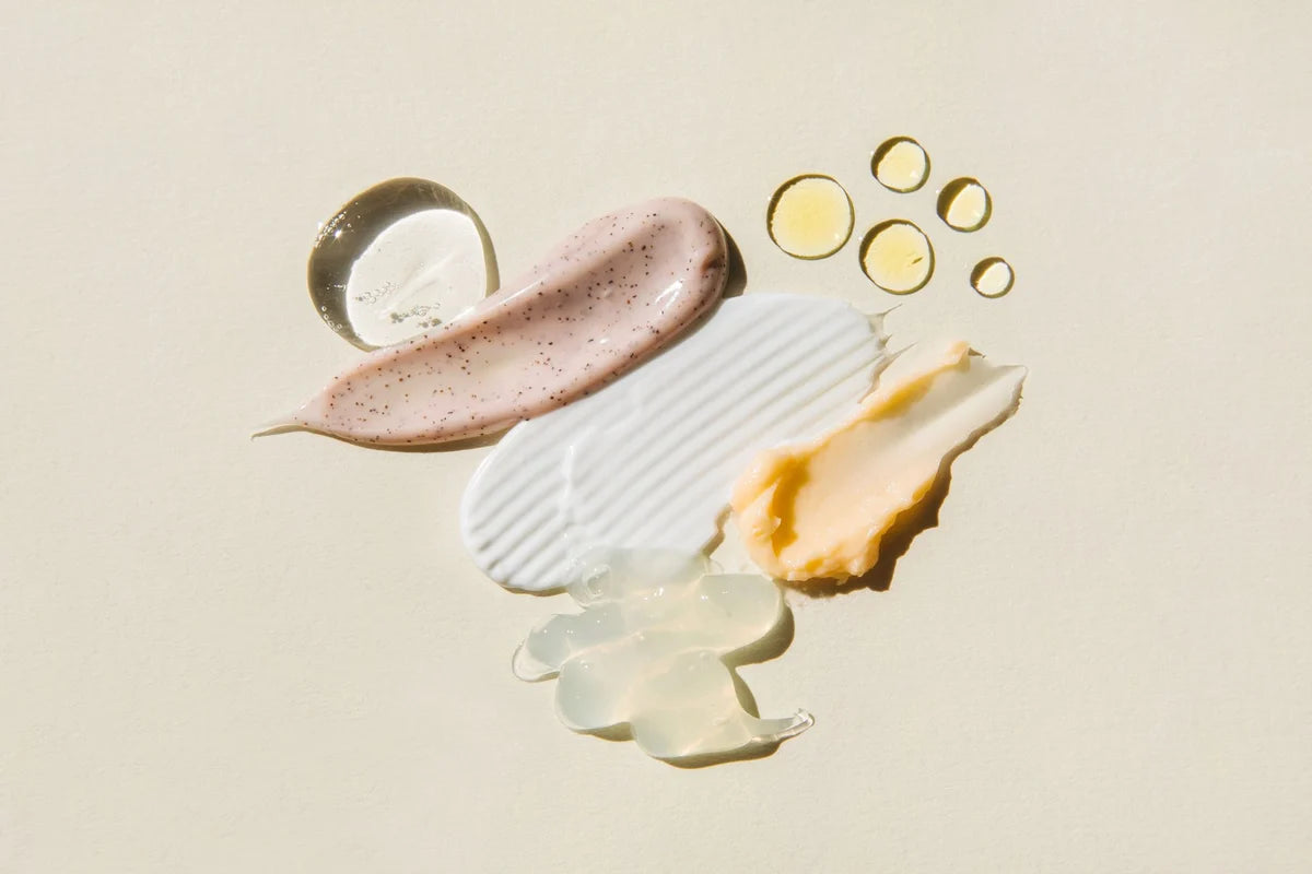 Cleanser, toner, serum and moisturiser textures laid out for a daily skincare routine
