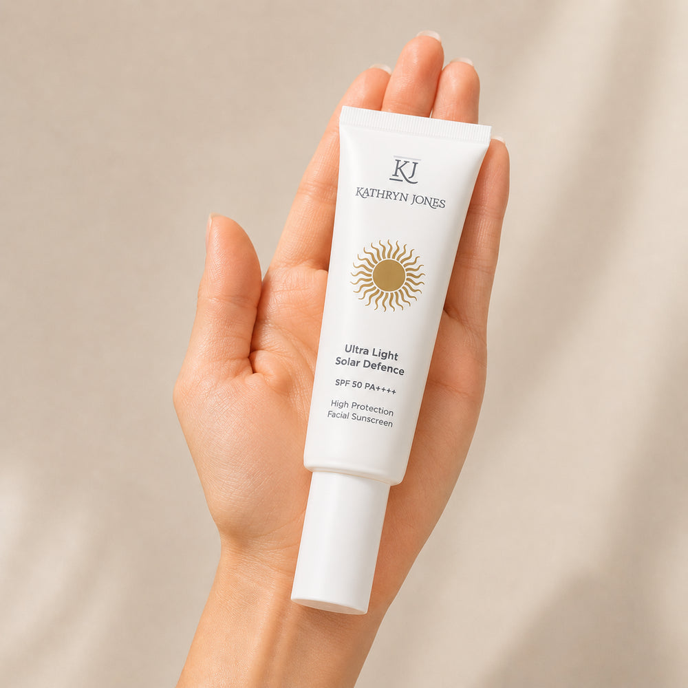KJ Serums Ultra Light Solar Defence SPF 50 PA++++ sunscreen tube held in the palm of a hand, showing its compact 50mL size